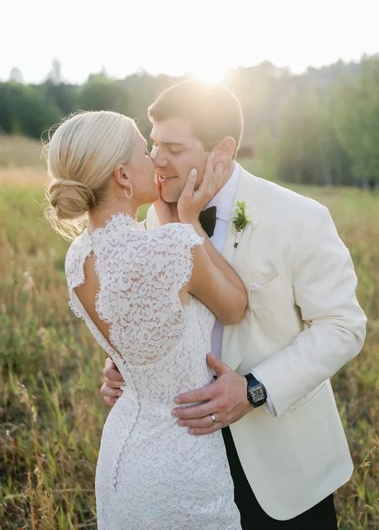 married couple kissing in front of sunset at Bachelor Gulch