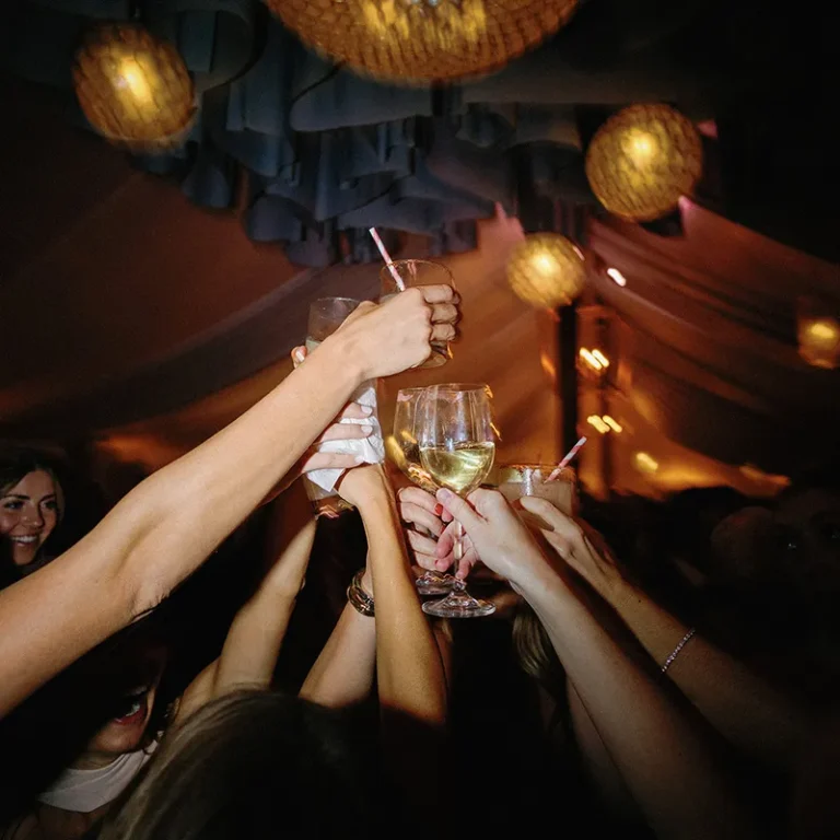 wedding guests raising drinks for a toast
